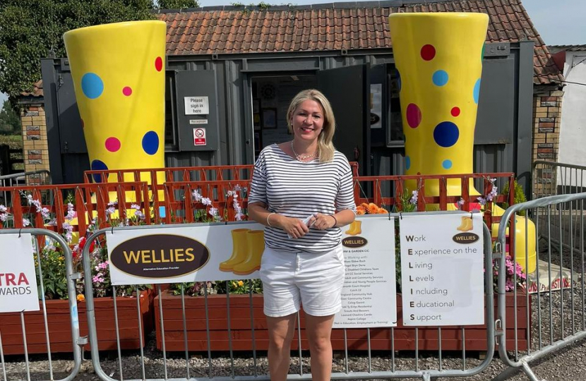 Laura in front of Wellies farm sign