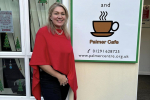Laura in front of dementia friendly cafe sign