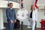 Laura Anne Jones MS and James Evans MS pictured in front of HMS Cambria sign