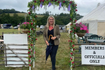 Laura in front of Machen Show Sign
